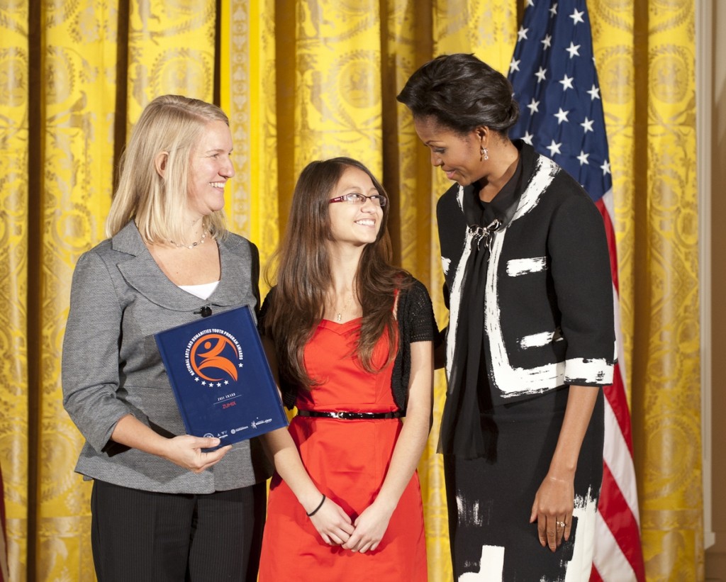 ZUMIX’s Madeleine Steczynski and Ixchel Garcia proudly accept the National Youth Arts and Humanities Program Award from First Lady Michelle Obama.